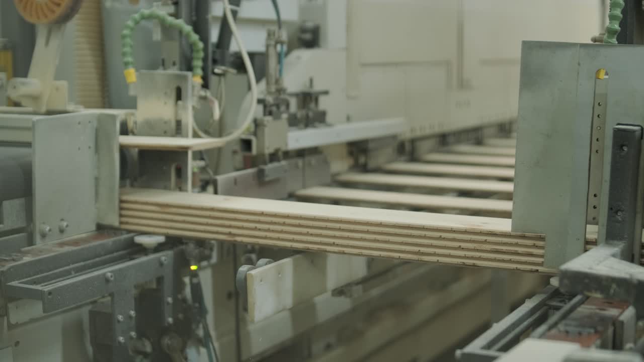 Automated Machine Processing Wooden Planks in a Factory