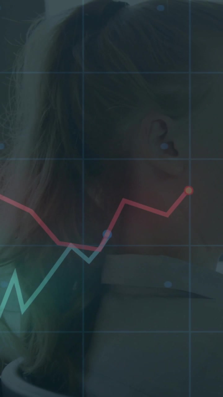 Vertical video: Woman in profile, charts appearing over shoulder while camera widening for business