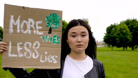 close up of an girl holding a placard