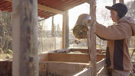 SLOW-MOTION---Beautiful-shot-of-a-cool-hipster-girl-emptying-the-food-waste-bucket