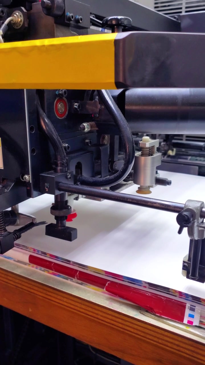 Close up of paper feeding mechanism on industrial printing press