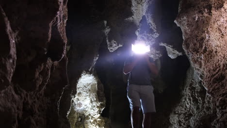 a man exploring a cave with the torch a man exploring a cave with the torch