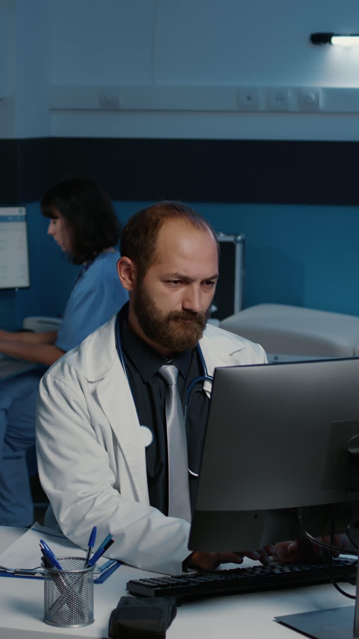 Vertical video: Specialist doctor in medical coat smiling at camera while analyzing patient expertise