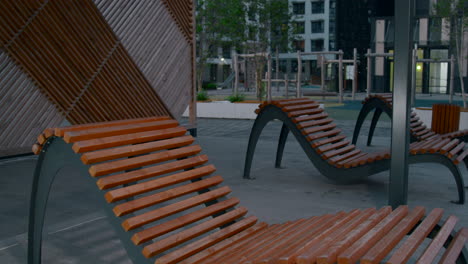 modern wooden loungers in urban park