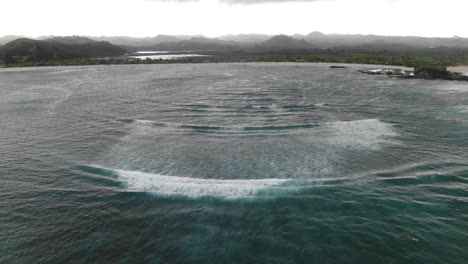 aerial view of ocean waves breaking on a beach