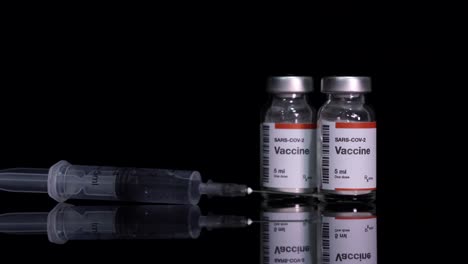 coronavirus vaccine bottles preparing by nurse hands for injection