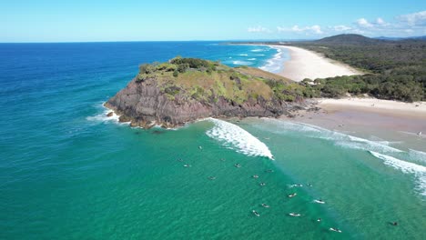 norries head and cabarita beach on tweed coast with surfers on sea