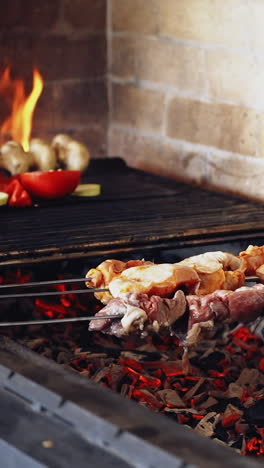 meat on grill on skewers. close up of roasted meat cooked at barbecue