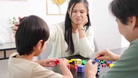 a family enjoys quality time together, playing with colorful building blocks in a bright, cheerful setting