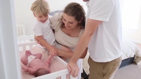 a loving family cherishes precious moments with their adorable newborn and toddler in a cozy nursery a loving family cherishes precious moments with their adorable newborn and toddler in a cozy nursery