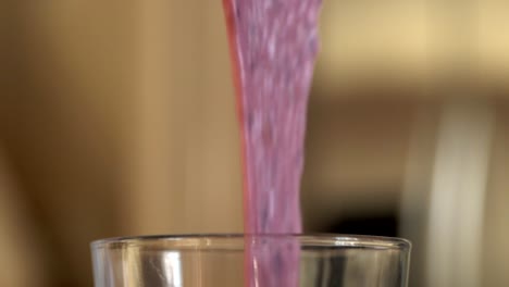 smoothie being poured into glass in slow motion