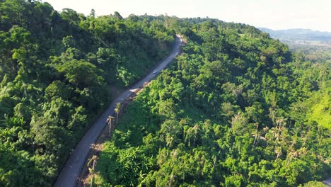 Aerial-drone-shot-of-truck-car-up-winding-road-on-headland-coastline-of-rainforest-jungle-travel-tourism-town-in-Port-Vila-South-Pacific-Islands-Vanuatu-4K