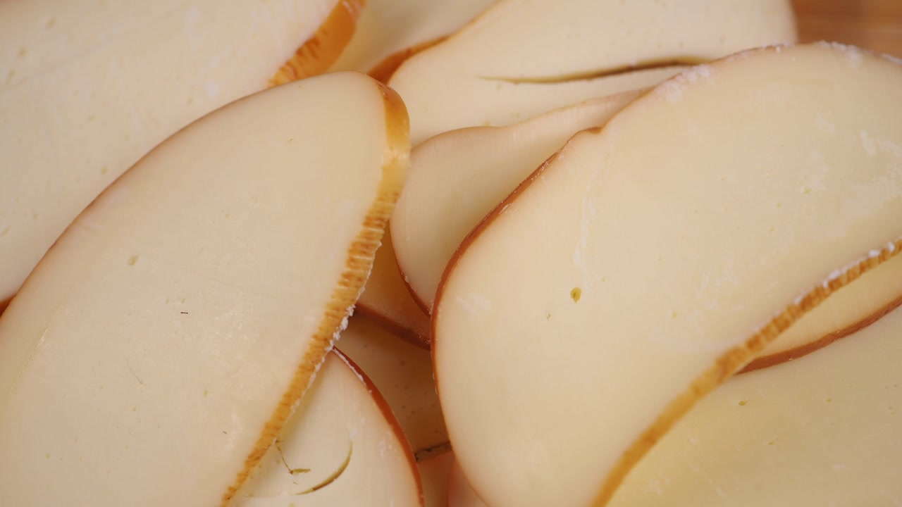 Fresh Sliced Smoked Cheese on Cutting Board