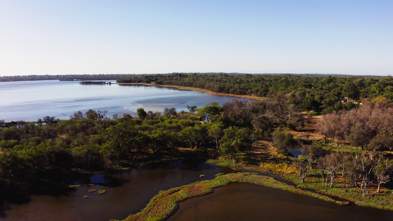 Descending drone push shot over a narrow isthmus between two large river estuaries