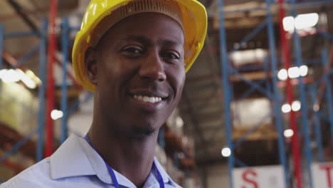 portrait of a young man wearing a hard hat in a warehouse 4k