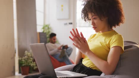 Mixed-race-woman-working-on-computer-in-creative-office