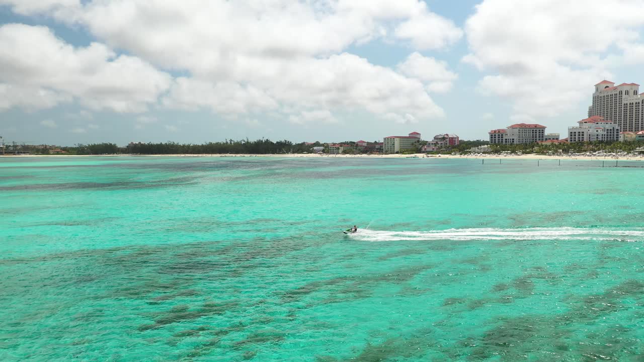 Drone Aerial View of Jet Ski in Emerald Sea Water by Coast of Nassau, Bahamas