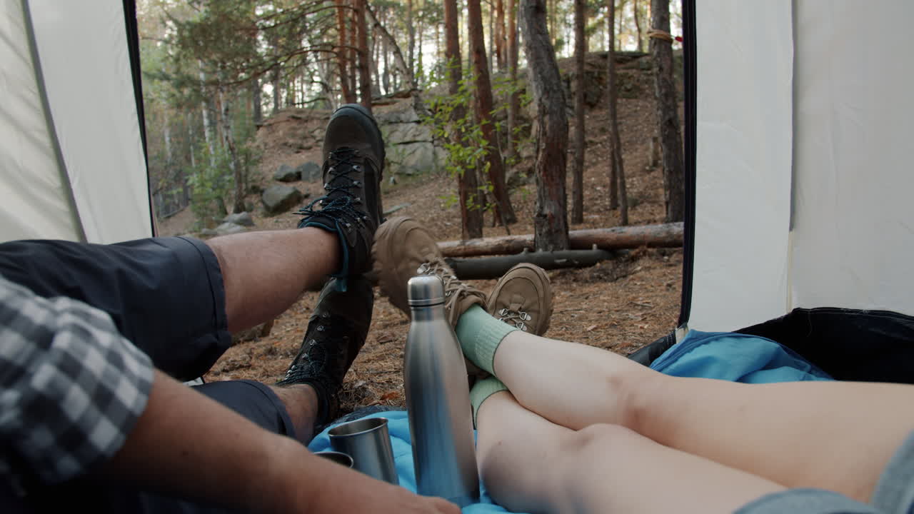 Couple Relaxing in a Tent in the Forest