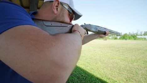 sportsman shoots from a double-barreled shotgun, a sports field for a shooting test is shooting at flying skeet