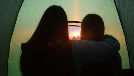 girls watching the sunset from a tent camp in the carpathians girls watching the sunset from a tent camp in the carpathians ukraine