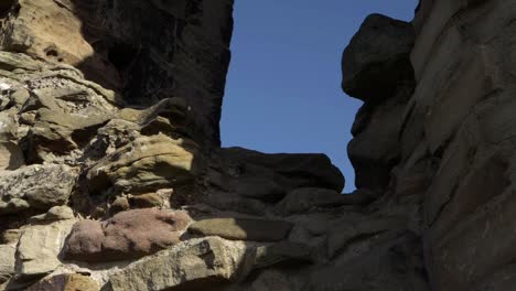 castle ruins window against blue sky panning shot