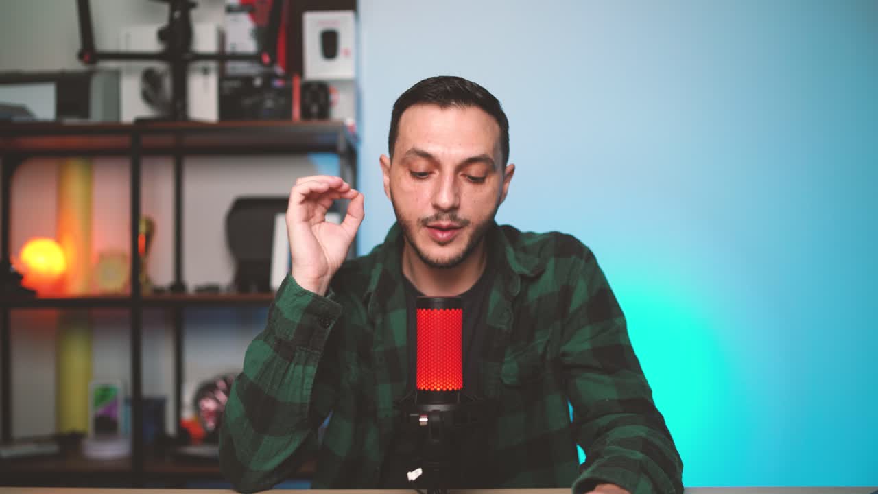 Male podcaster records an episode while confidently speaking into a professional microphone in a stylish, modern studio. Concept of online broadcasting and content creation.