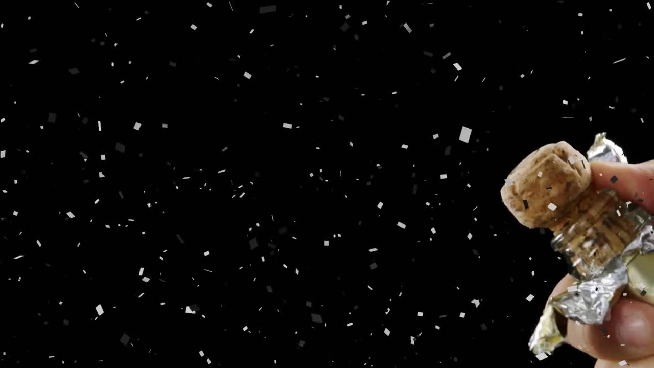 Animation of confetti over man opening champagne on black background