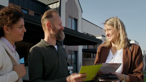 group of people viewing property brochures