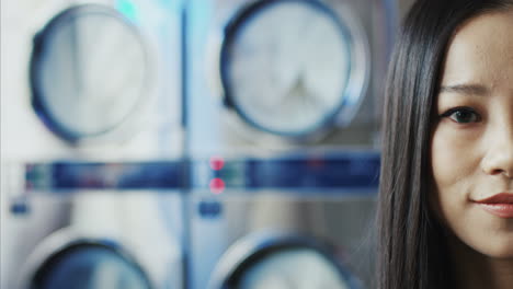 Close-Up-Of-Half-Face-Of-Young-Pretty-Stylish-Woman-With-Red-Lips-And-In-Yellow-Glasses-Smiling-To-Camera-In-Laundry-Service-Room-1