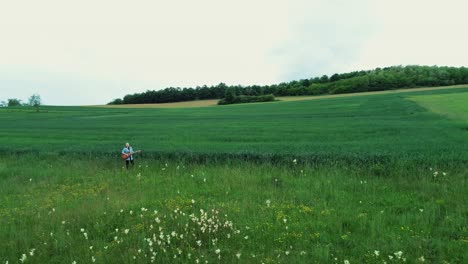 a woman plays the guitar in nature