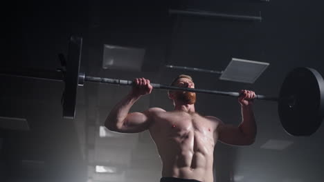 Slow-motion-of-crossfit-athlete-performs-clean-and-jerk.-Young-man-doing-the-clean-and-jerk-weightlifting-exercise-at-the-gym.