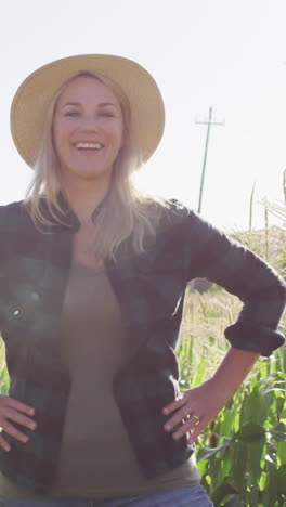 video of happy caucasian woman standing in field on sunny day