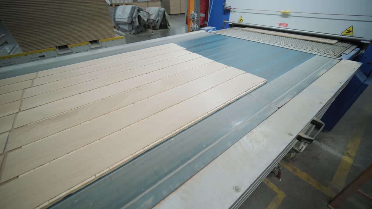 Wooden Planks Moving Along Conveyor Belt in a Factory