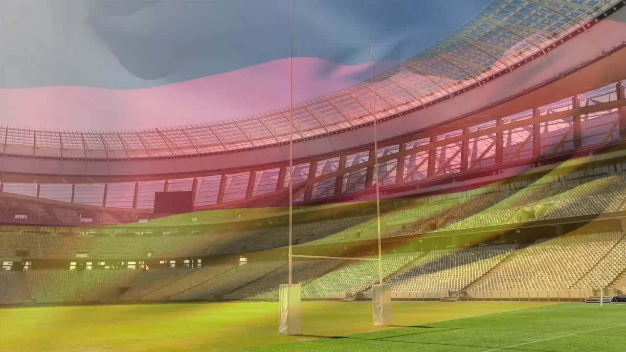 bandera ondeando frente a un estadio