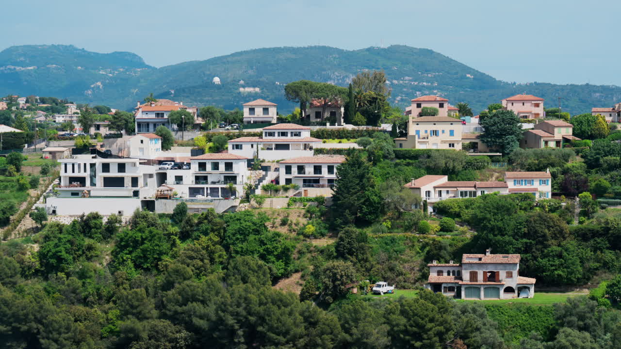 View of the Cremat village surrounded by green trees and mountains