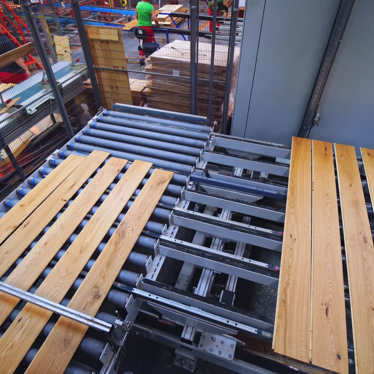 Process of making parquet boards indoors. Modern industrial factory for producing wooden laminate. Production of panels for flooring.