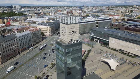 cinematic aerial footage of the riga clock tower flying away to give a wider view in latvia, europe