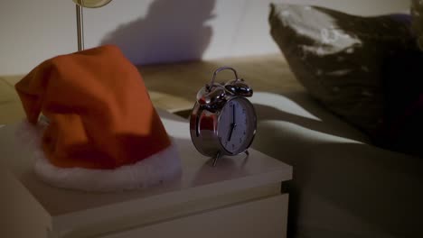 santa claus hears the alarm clock and wakes up