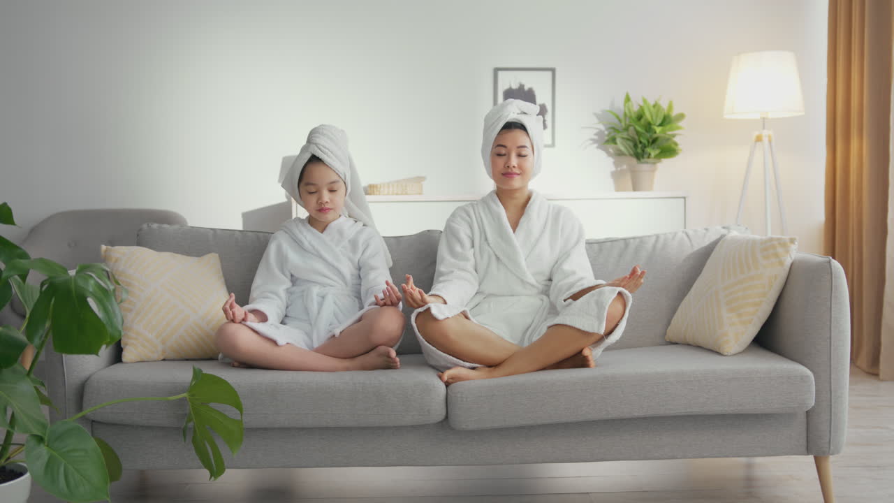 Mother and Daughter Meditating at Home