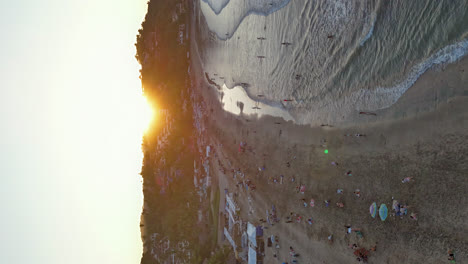 aerial hyperlapse of sayulita beach sunset, nayarit, with glowing sky and ocean waves, vertical