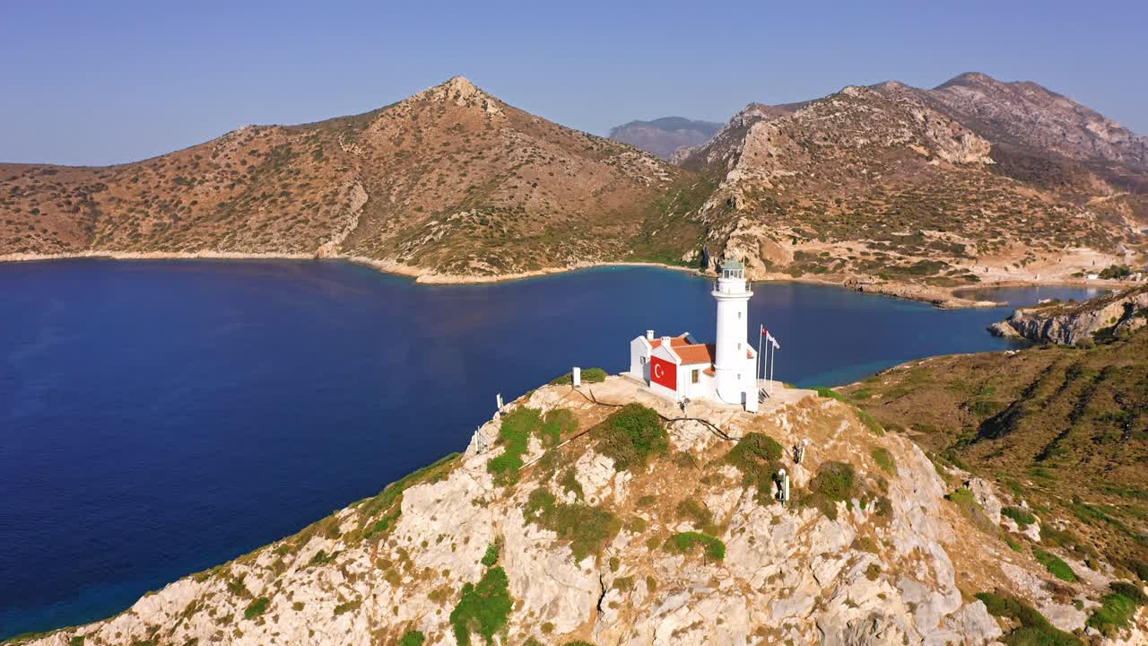 Sunny Seascape With The Lighthouse On Rocky Seashore