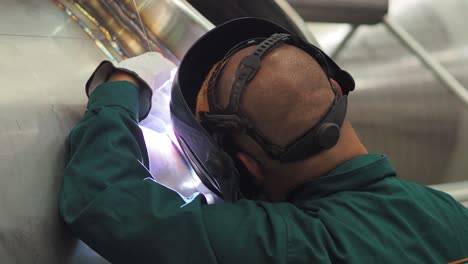 welder, using vig, tig, mig mag method to welding stainless steel parts, close up