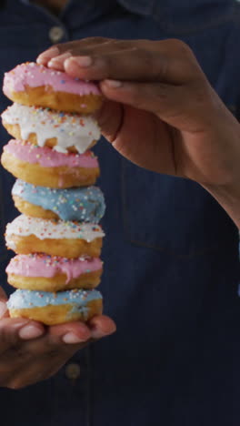 video of man holding donuts on white background