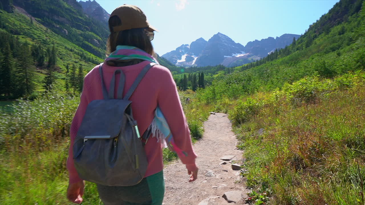 Hiking trail following women female model actress hand in tall green grass Maroon Bells 14er peaks Wilderness Aspen Snowmass Rocky Mountain Colorado summer stunning morning Cinematic gimbal stabilize