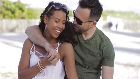 beautiful couple embracing on shoreline