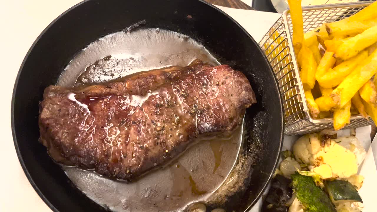 Savor the succulence of a grilled beef steak paired with crispy french fries &mdash;a classic Portuguese dish that promises to delight every palate