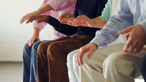 group of senior people sitting together with holding hands 4k