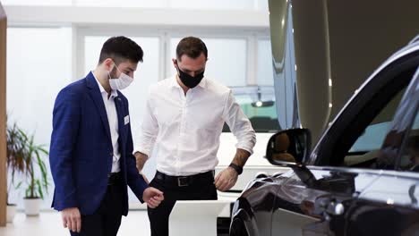 a salesman tells specifications of a new car model to a client