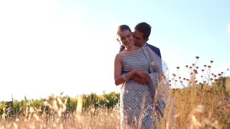 happy indian couple on their wedding day outdoors - wide shot