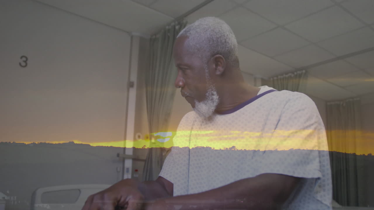 Sunset landscape animation overlay on elderly man wearing hospital gown